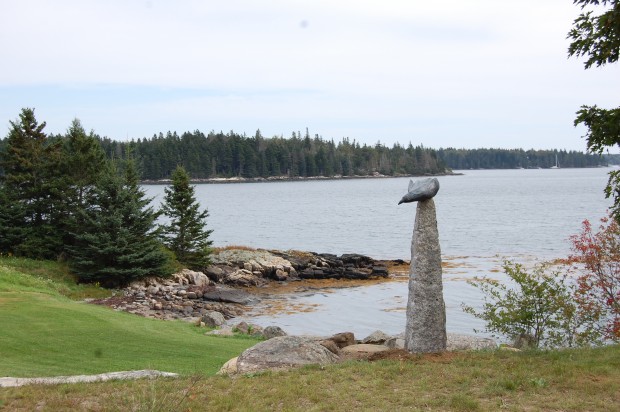 Sculpture sited on landscape Raven by Ray Carbone bronze, granite photo by June LaCombe